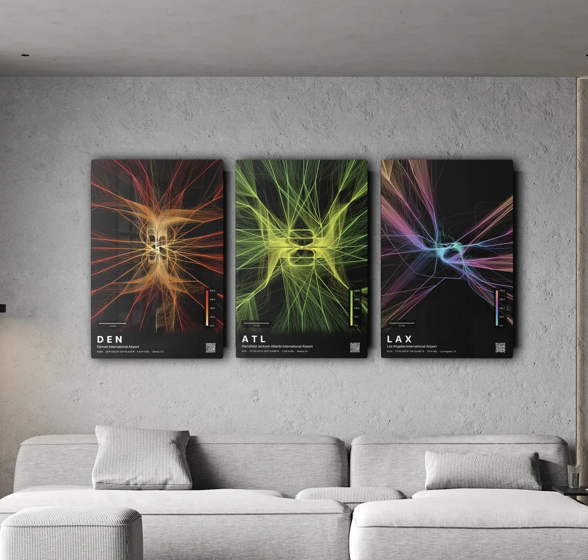 Three SkyPath Studio airport flight-path prints on aluminum, hung above a sofa
