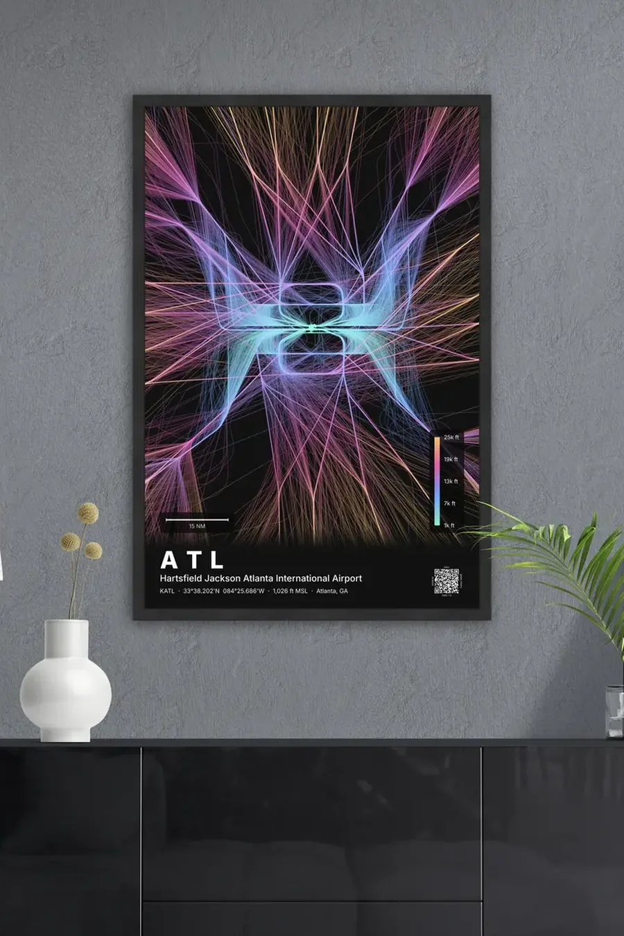 The finished ATL flight path print, framed in black, hanging above a sideboard